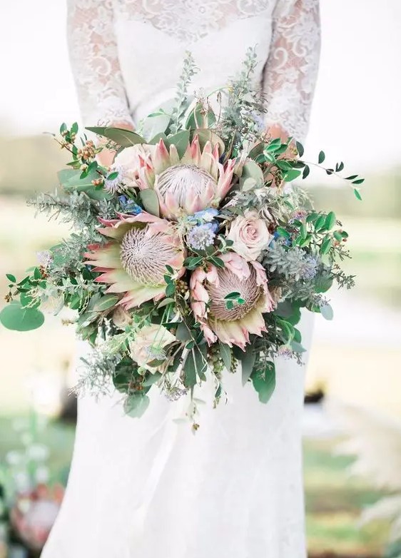 a wedding bouquet with king proteas, eucalyptus and greenery for a boho bride