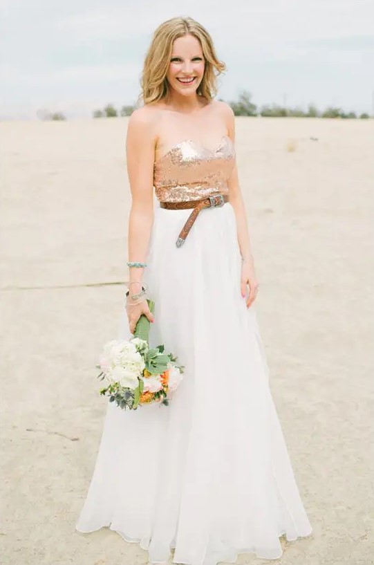 a wedding dress with a flowy skirt, a sequin strapless bodice and a brown leather belt to make a statement