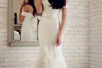 an off the shoulder mermaid wedding dress with a belt and a feathered skirt is a very sophisticated solution