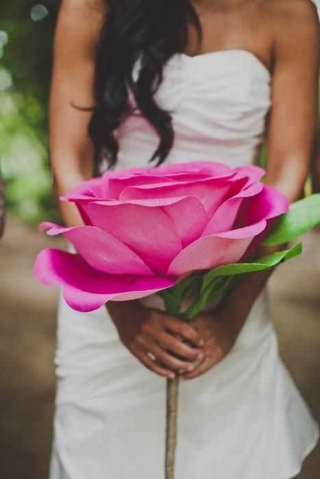 an oversized pink paper rose can be used as a wedding bouquet or decor, you can make one yourself