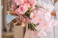 an oversized pink wedding bouquet with roses, orchids, baby’s breath, foliage is amazing for spring and summer brides