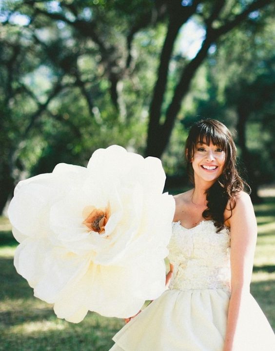 an oversized white flower can be rocked as a wedding bouquet or decor, you can make such a flower yourself