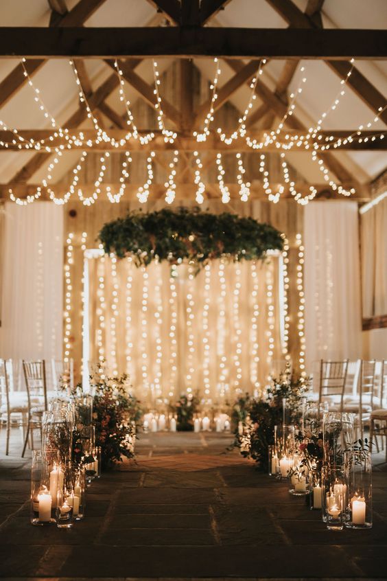 string light canopies and candles on the floor are a great combo for a barn ceremony space and for the reception, too