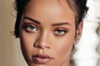 Rihanna wearing smokey eyes, a dusty pink shiny lip, a touch of blush and highlighter looks super chic