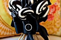 a black and white candy wedding bouquet with an elegant ribbon and brooch is a gorgeous solution for a Halloween wedding