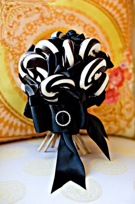 a black and white candy wedding bouquet with an elegant ribbon and brooch is a gorgeous solution for a Halloween wedding