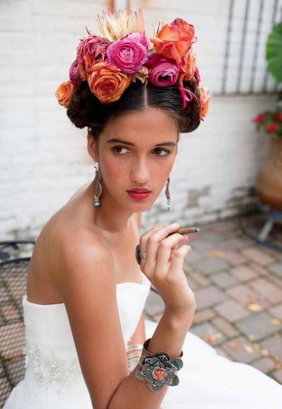 a bold tropical flower crown with hot pink and orange blooms and a king protea on top is an amazing way to add color to the look