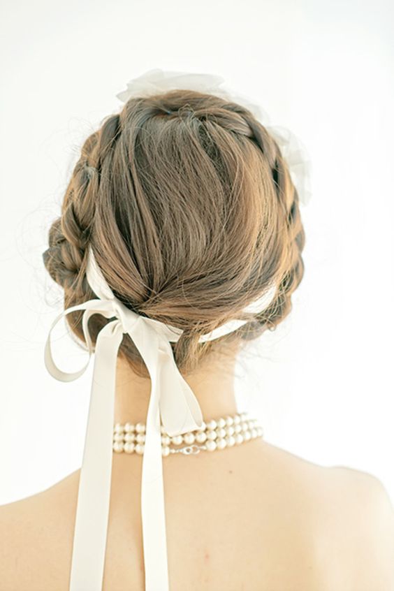 a braided halo updo with a delicate neutral ribbon for an accent is a chic and refined solution to rock at your wedding