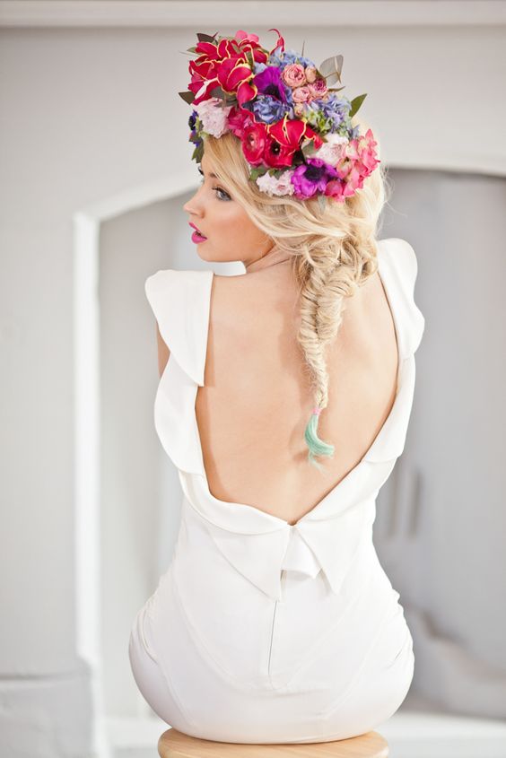 a bright floral crown with deep red, pink, blue and violet blooms and leaves is a bold and chic idea for a summer boho wedding