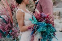 a bright wedding bouquet of spray painted feathers and pampas grass, ostrich feathers and sheer ribbons is a bold idea