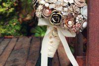 a chic vintage brooch wedding bouquet with a ribbon wrap and a bow is a very chic and elegant idea for a vintage-loving bride