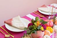 a colorful fall tablescape with bright painted pumpkins, blooms and dip dye napkins