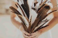 a creative boho wedding bouquet of feathers and branches is a cool and very easy idea that you can compose yourself anytime