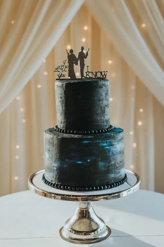 a galaxy wedding cake with Han Solo and Leia silhouettes and their phrases for a Star Wars wedding