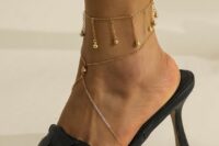 a gold chain anklet with multiple gold bead pendants and a matching foot chain for an ultimate look