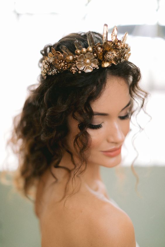 a gold flower and crystals bridal crown is a catchy idea, gold accessories are always on and a crown will make your look royal