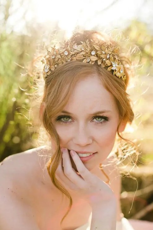 a gorgeous and shiny gold flower and leaf crown with rhinestones is a lovely solution for a summer or fall bride, such a crown won't wither