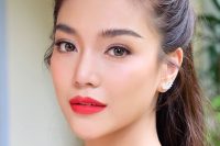 a gorgeous bold Asian makeup with a matte red lip, extended eyelashes, chic eyebrows and blushes looks amazing