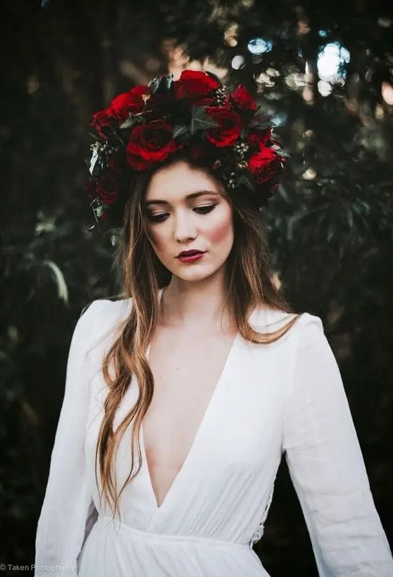 a large moody crown with red roses and dark greenery for a fall boho bridal look