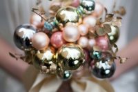 a lovely matte and shiny Christmas ornament wedding bouquet with gilded foliage and gold ribbons is a delicate idea for a winter bride