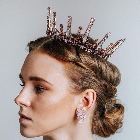 a lovely pink and moon crystal bridal crown with intricate detailing and flower earrings for a fantastic queen-like look