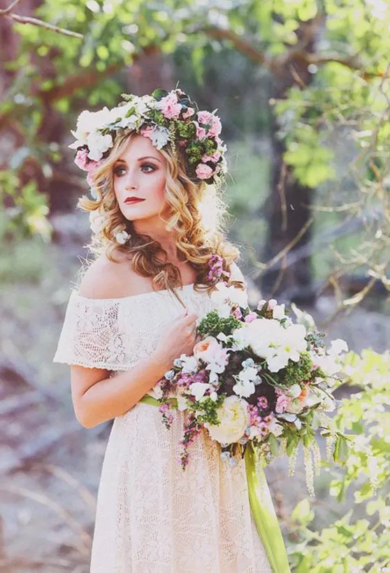 a lush floral crown with pink and white blooms and much greenery plus a matching bouquet for a summer bride