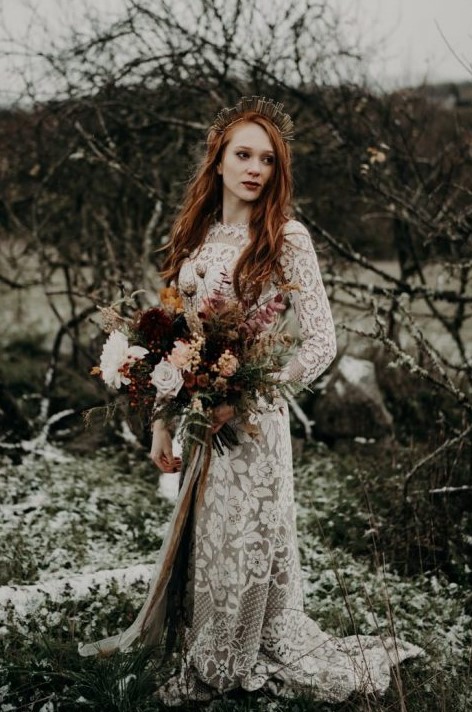 a moody fall bride wearing a unique metallic crown and long red hair down for a bold statement look