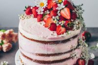 a naked wedding cake with strawberries, cherries and some white wildflowers is a gorgeous idea for a relaxed summer wedding