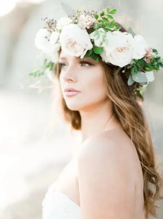 a neutral large floral crown with blush peonies and blooms plus berries and greenery for a romantic bride