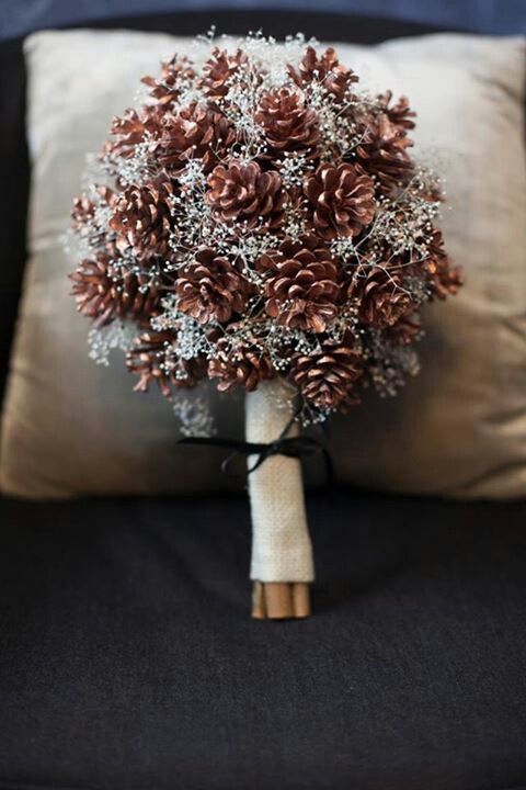 a pinecone wedding bouquet with silver touches and in a burlap wrap is a stylish idea for a winter rustic bride