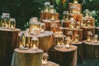 a rustic wedding altar of tree stumps with mason jars that are candle lanterns can be composed by you yourself, add other decor touches