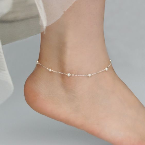 a silver chain plus pearl anklet is a tiny and delicate accessory that every bride and every girl can wear