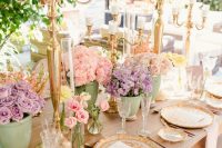 a sophisticated vintage pastel bridal shower with lilac and pink blooms in pots, candelabras, gilded plates and chargers and neutral napkins