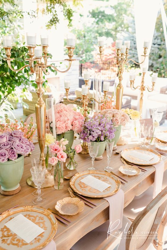 a sophisticated vintage pastel bridal shower with lilac and pink blooms in pots, candelabras, gilded plates and chargers and neutral napkins