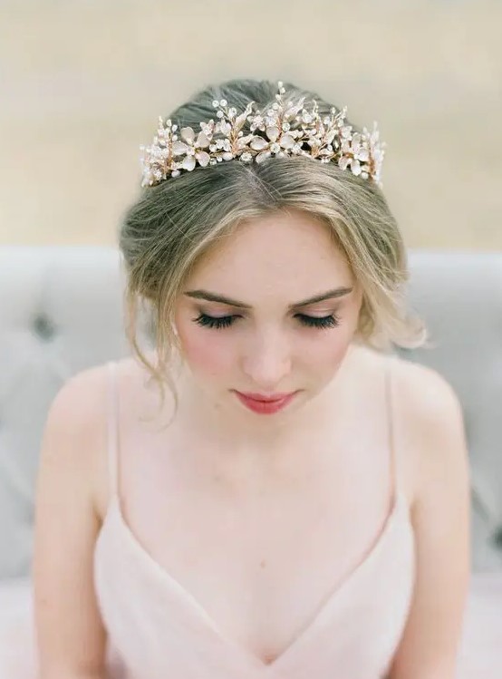 a statement floral tiara in gold, with rhinestones is a perfect solution for a romantic bridal look, perhaps with a pink wedding dress