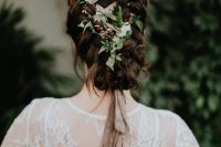 a unique braided low updo with a blush ribbon and fresh greenery interwoven looks very eye-catchy and boho