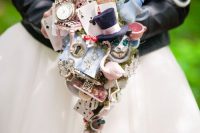 a whimsical Alice in Wonderland wedding bouquet of various elements that are inspired by the book is a jaw-dropping idea