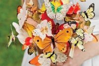 a whimsical and dreamy wedding bouquet made of paper butterflies is a very bright and cool idea for a summer bride