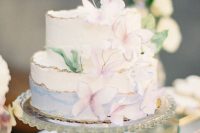a whimsical pastel bridal shower cake with blue watercolors, with pastel butterflies and greenery is an amazing idea for a vintage bridal shower