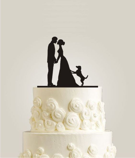 a white wedding cake with sugar blooms and a silhouette cake topper showing the couple and their dog is very cute