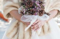 a winter wedding bouquet of pinecones, lilac blooms and sheer ribbons is a very cool idea that you can easily DIY