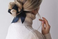 an elegant low bun interwoven with a black ribbon is a very chic idea, suitable for many bridal styles