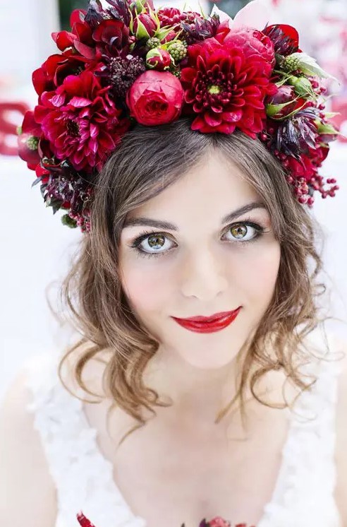 an oversized floral crown in the shades of red and burgundy plus a red lip for a bold fall bridal look