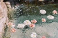 just a bit of pink and white blooms floating in your pool or fountain is a gorgeous idea for a wedding