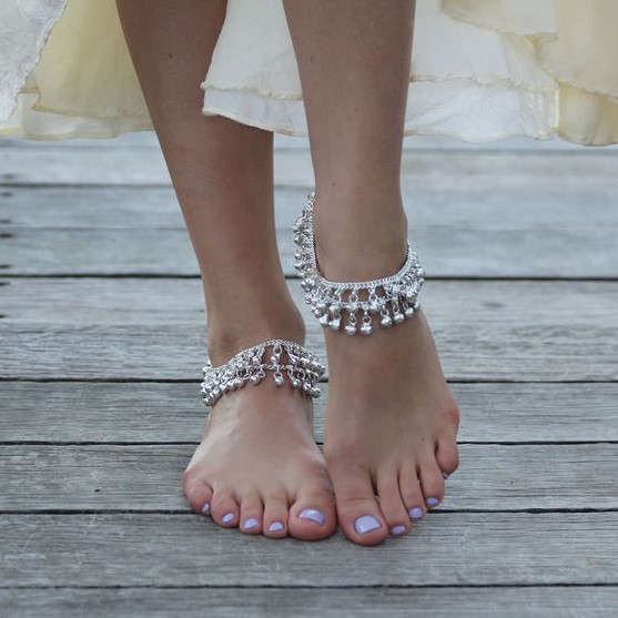 layered silver chain anklets with small silver bells are amazing for a gypsy or a boho bridal look