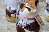 mason jars with s’mores and cookies on top, with twine and tags are amazing to serve desserts at the wedding