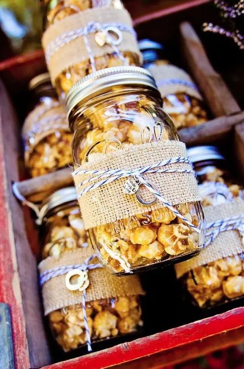 popcorn in jars, with burlap and twine is always a great idea of an eco-friendly wedding favor that is always to the point