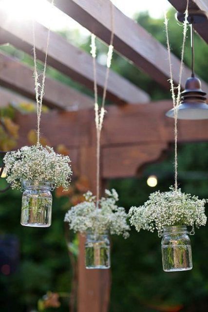 simple wedding decor with mason jars hanging down and white baby's breath is great for a rustic wedding