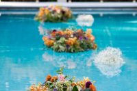 super bright floral and greenery arrangements floating in the pool will make your outdoor wedding decor veyr impressive