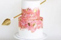 a stylish wedding cake with a golden arrow
